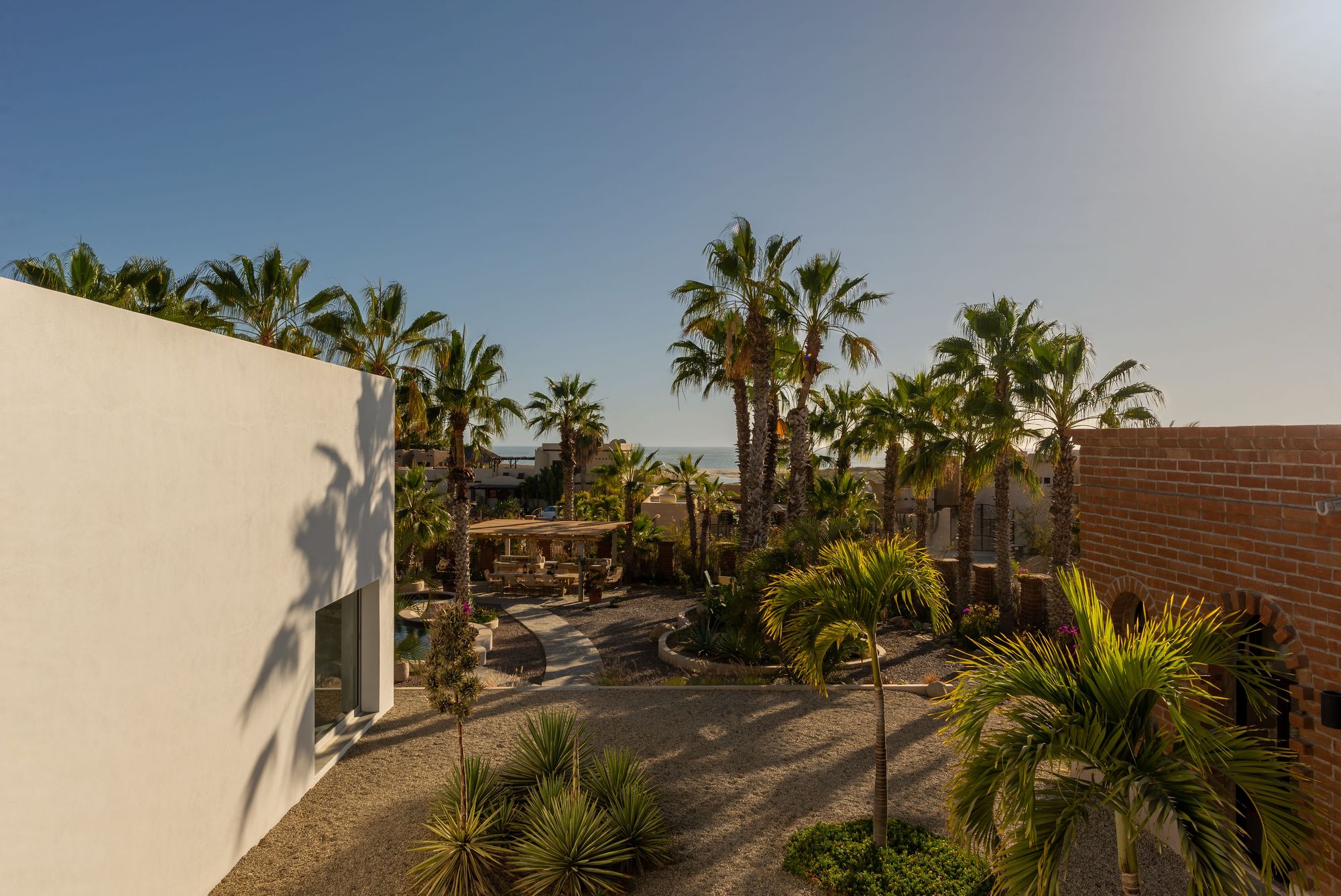 Overhead view of the courtyard paths, palms and buildings of the compound