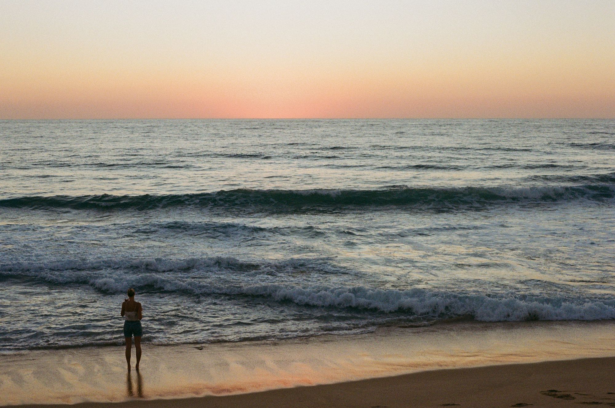 The Pacific at dusk near Todos Santos, a lone figure at the waterline